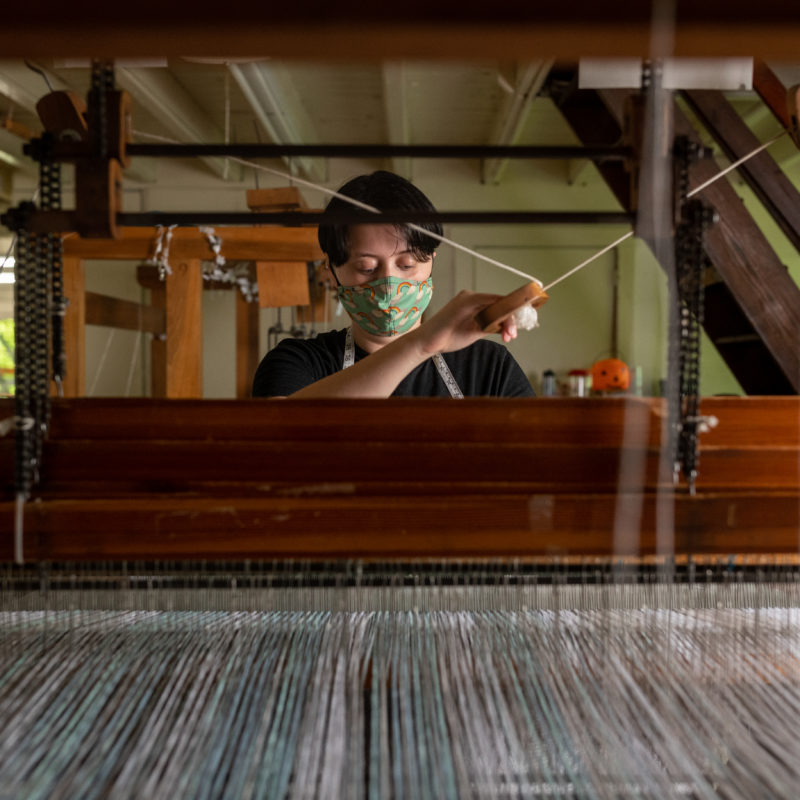 Emerson Croft at a weaving loom